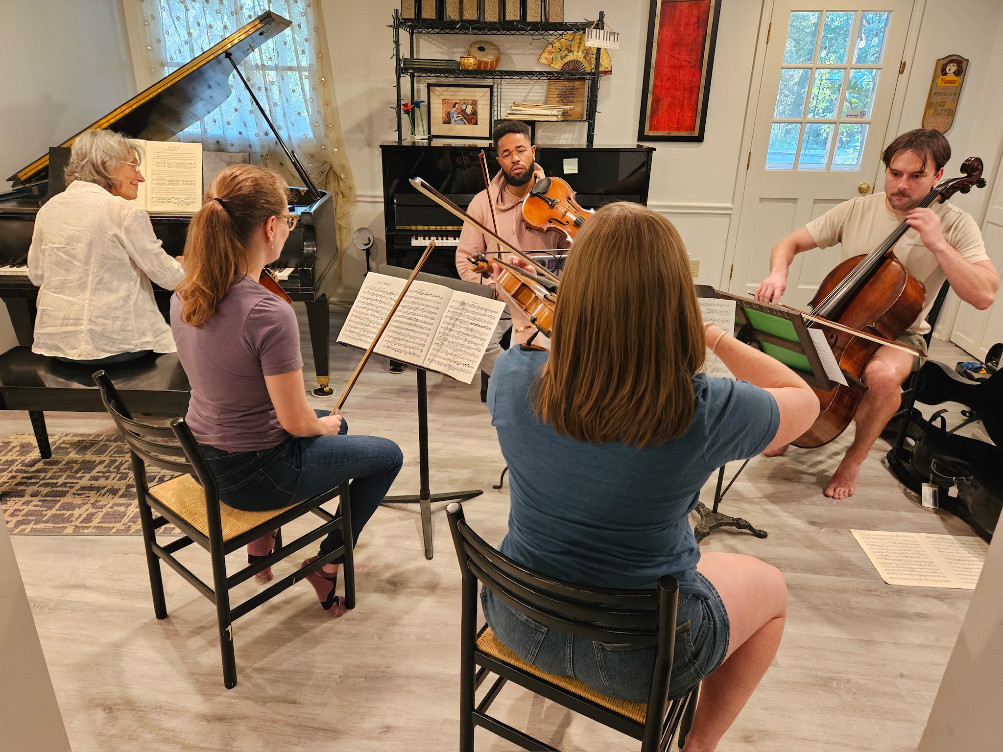 Brahms Quintet in rehearsal-Emily, Vanessa, Shirley, Drew, Alex string musicians playing instruments with a pianist in a home setting