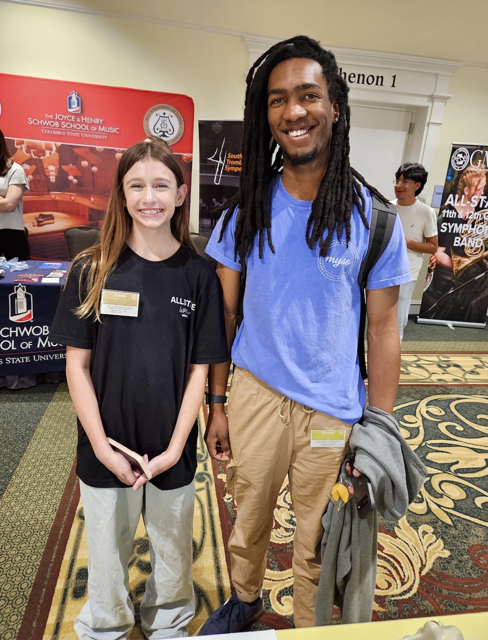 a young lady and young man posing together and smiling at the camera