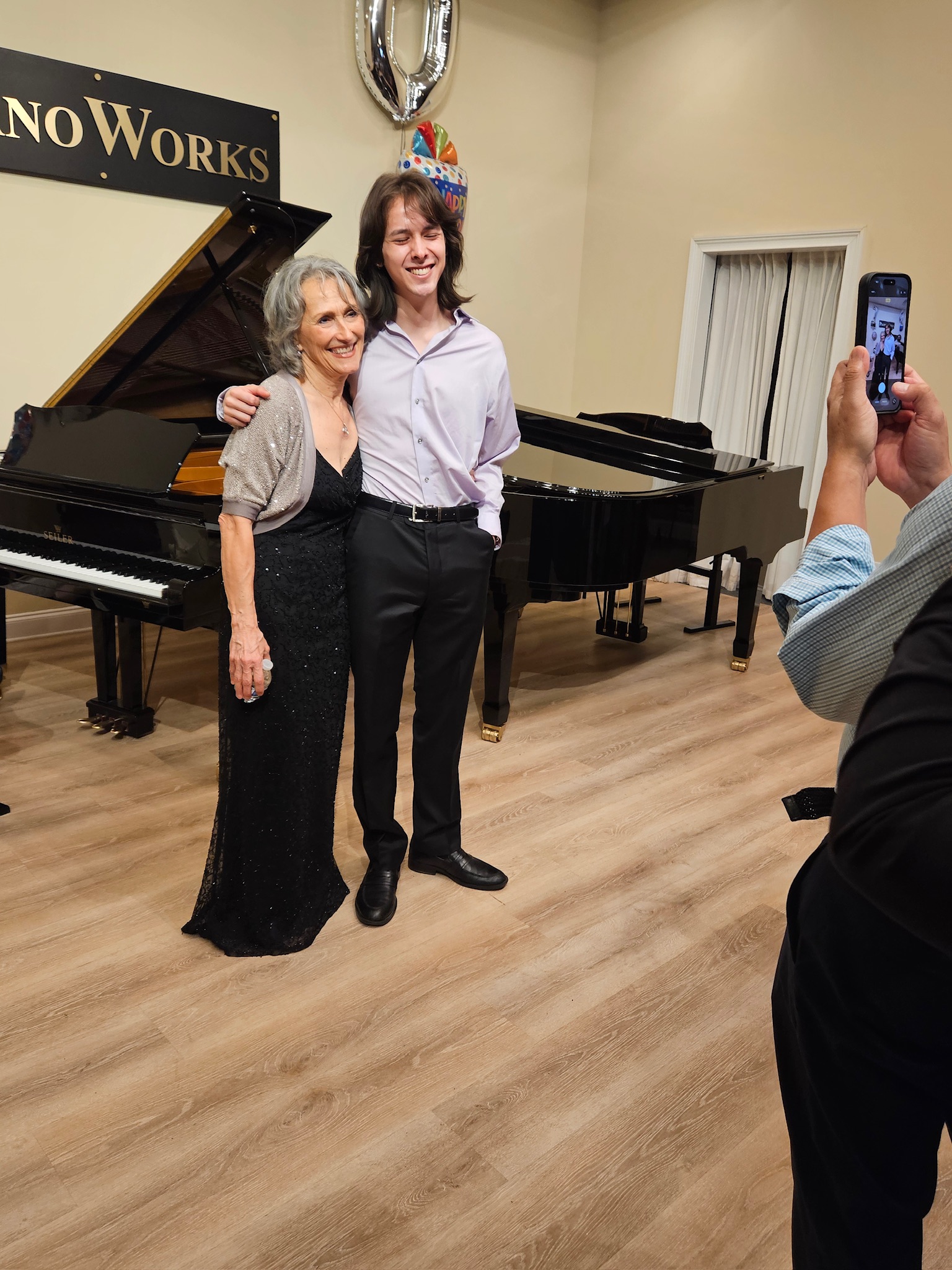 Shirley, Nicholas two musicians posing in front of a piano